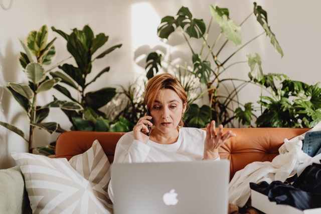 mom on phone and computer with college student